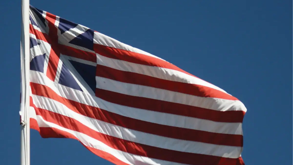 Continenal Union Flag waving on a flagpole against a bright blue sky
