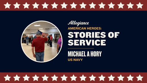 Michael A. Hory, a US Navy veteran, salutes while holding an American flag in a hall among other attendees