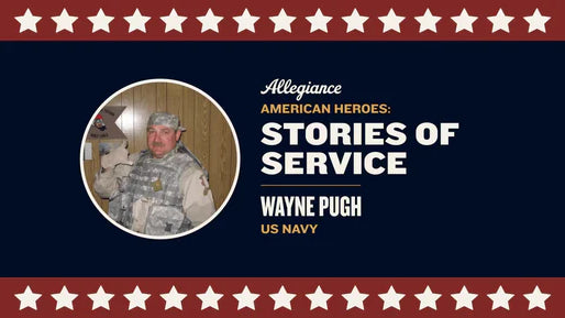 Wayne Pugh, US Navy veteran, in military uniform with a backdrop of wood paneling & a sign that reads "Operation Noble Eagle"