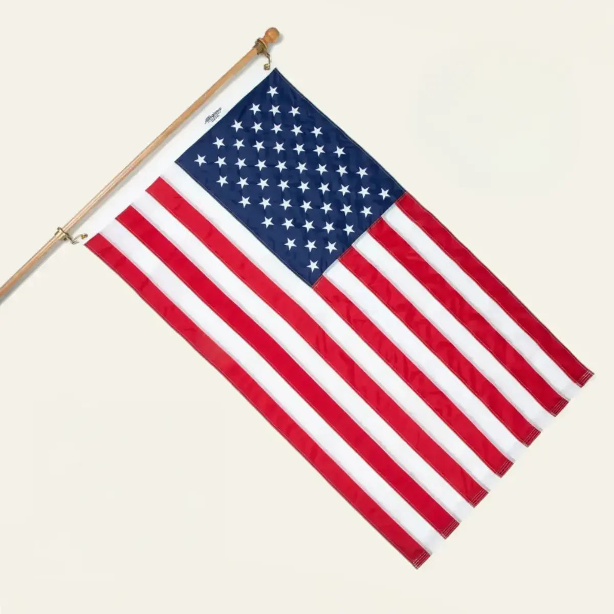 American flag mounted on a wooden pole against a plain white background.