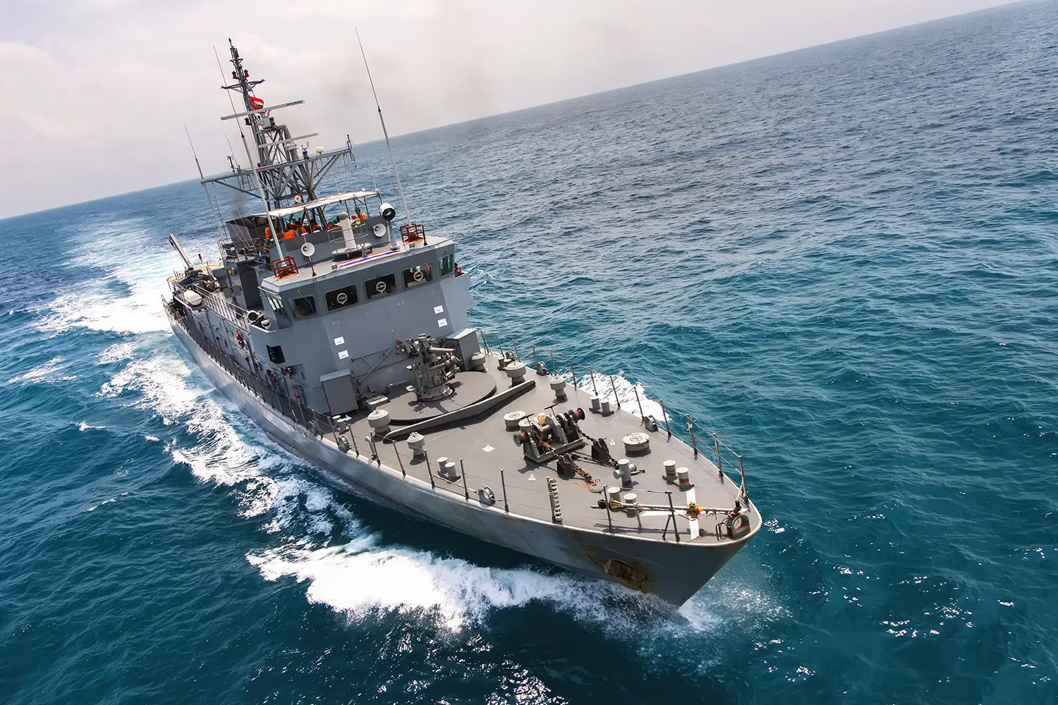 US Navy carrier sailing through the open ocean.